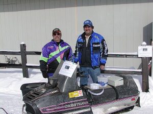 Jeff and Bear Schwaller President and Vice President of the NEW Low Buck Vintage Riders by the snowmobile that they were raffling off